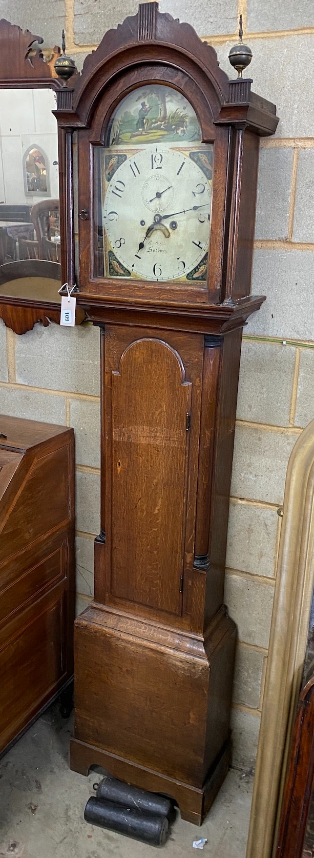 An early 19th century oak cased 8 day longcase clock, the arched painted dial marked Sudbury, height 212cm